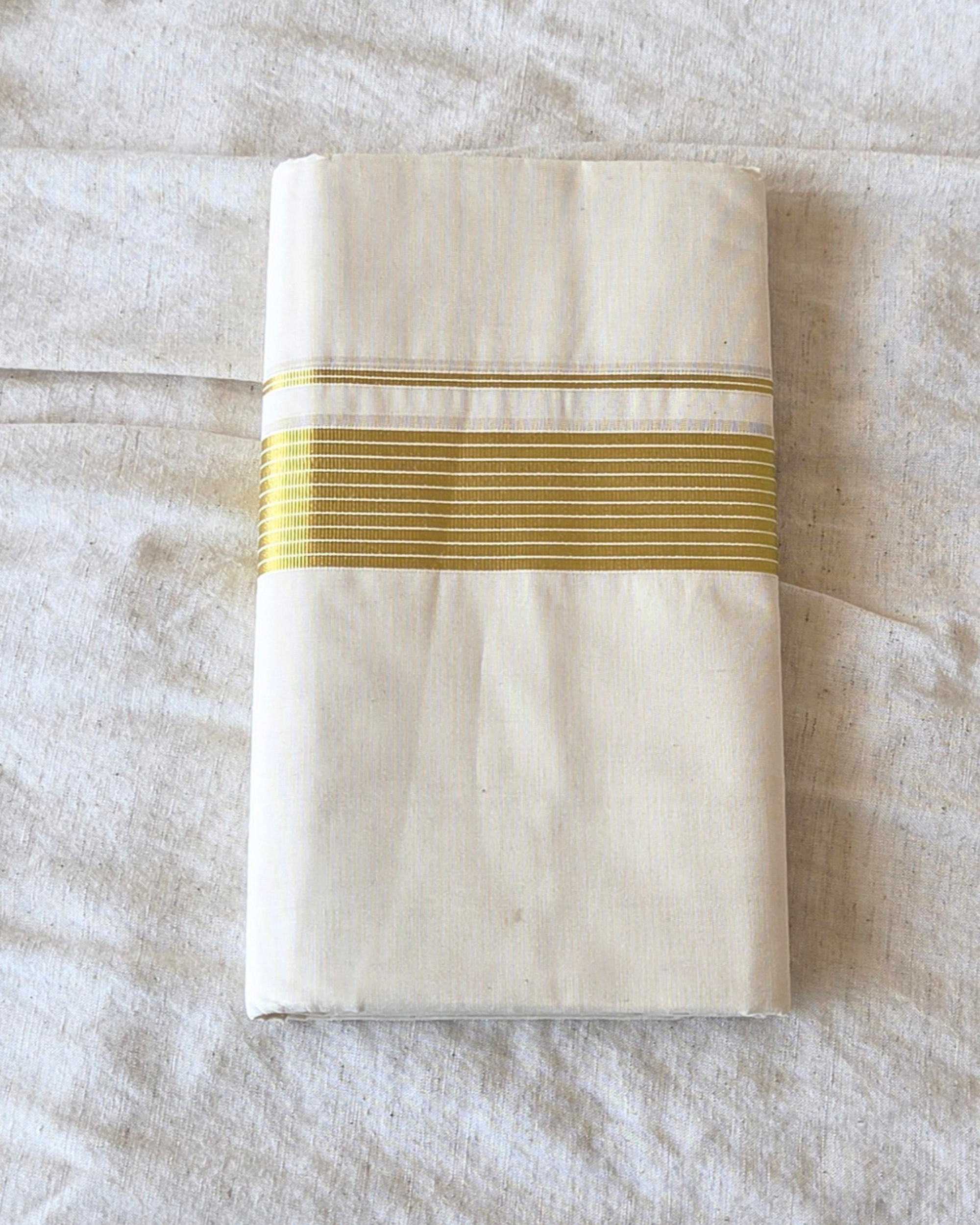 Broad kasavu double mundu angled fold — dense gold zari border, Balaramapuram handloom cotton Canada — Atelier Soza