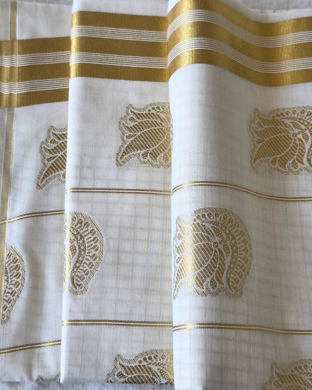 Kerala kasavu saree folded — peacock butta gold check body border — Atelier Soza Canada