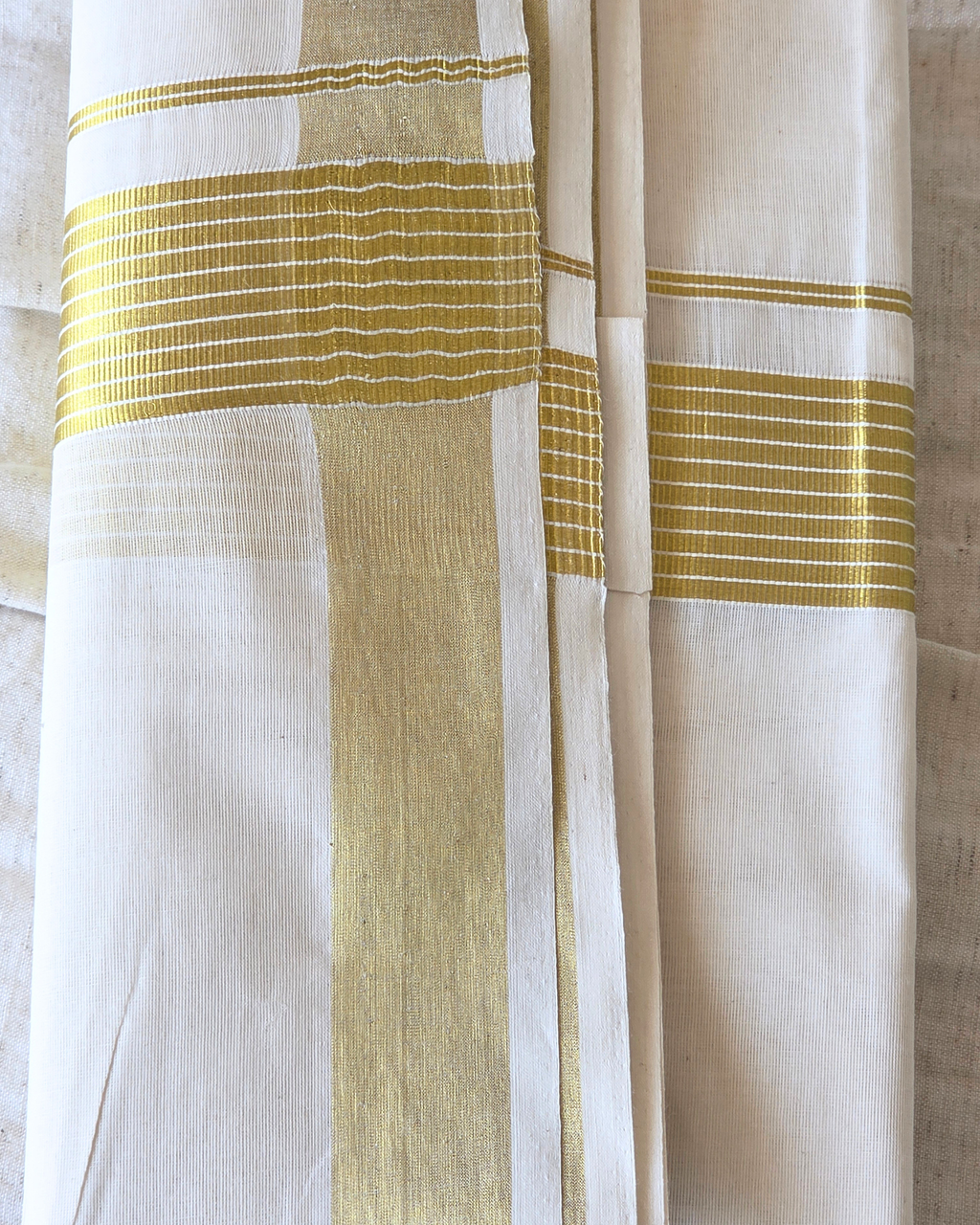 Broad kasavu double mundu angled fold — dense gold zari border, Balaramapuram handloom cotton Canada — Atelier Soza