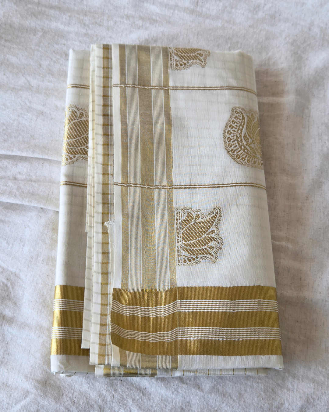  Kerala cotton saree laid out — peacock lotus butta kasavu border Canada